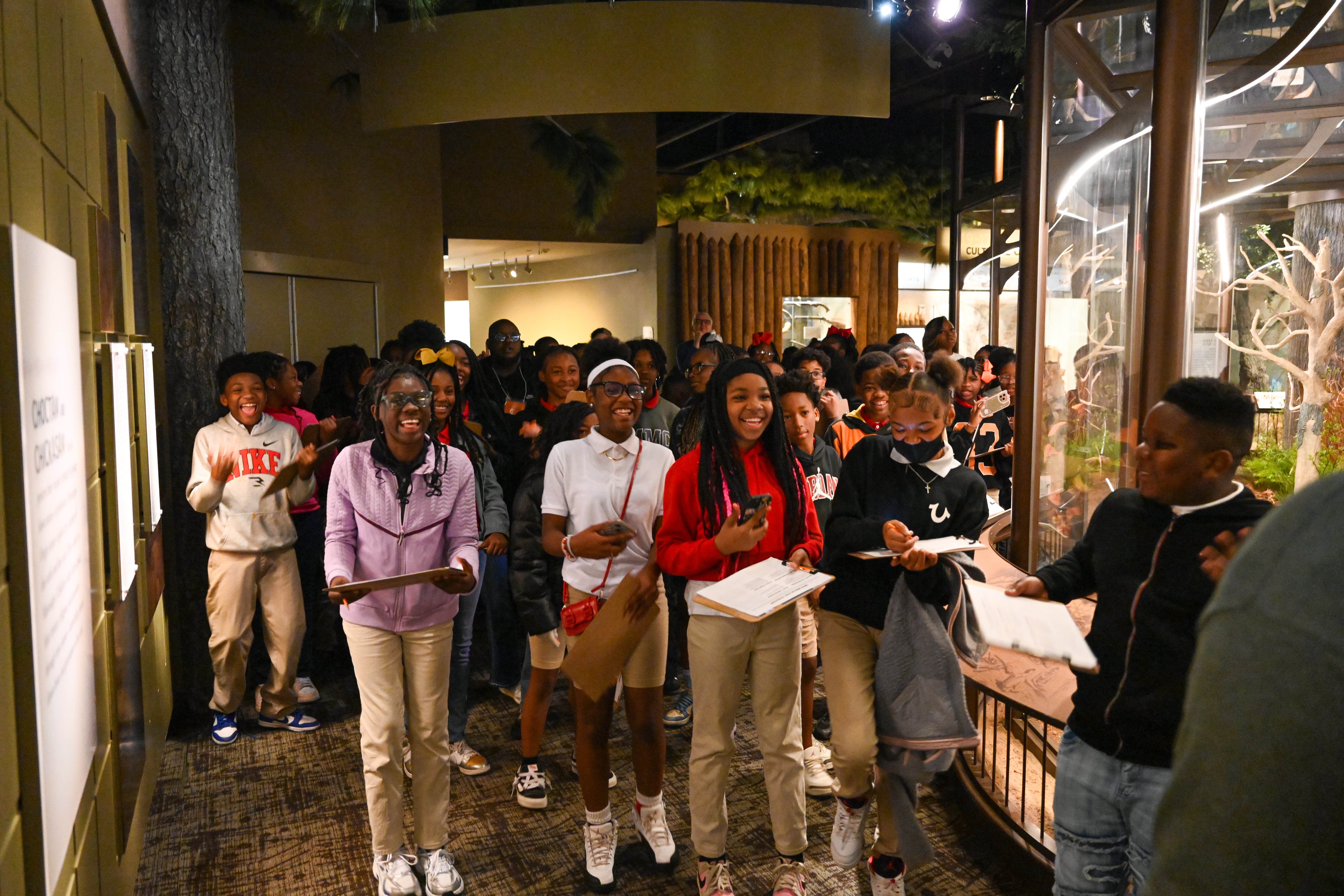 Students in the Museum of Mississippi History smile during a guided tour. 