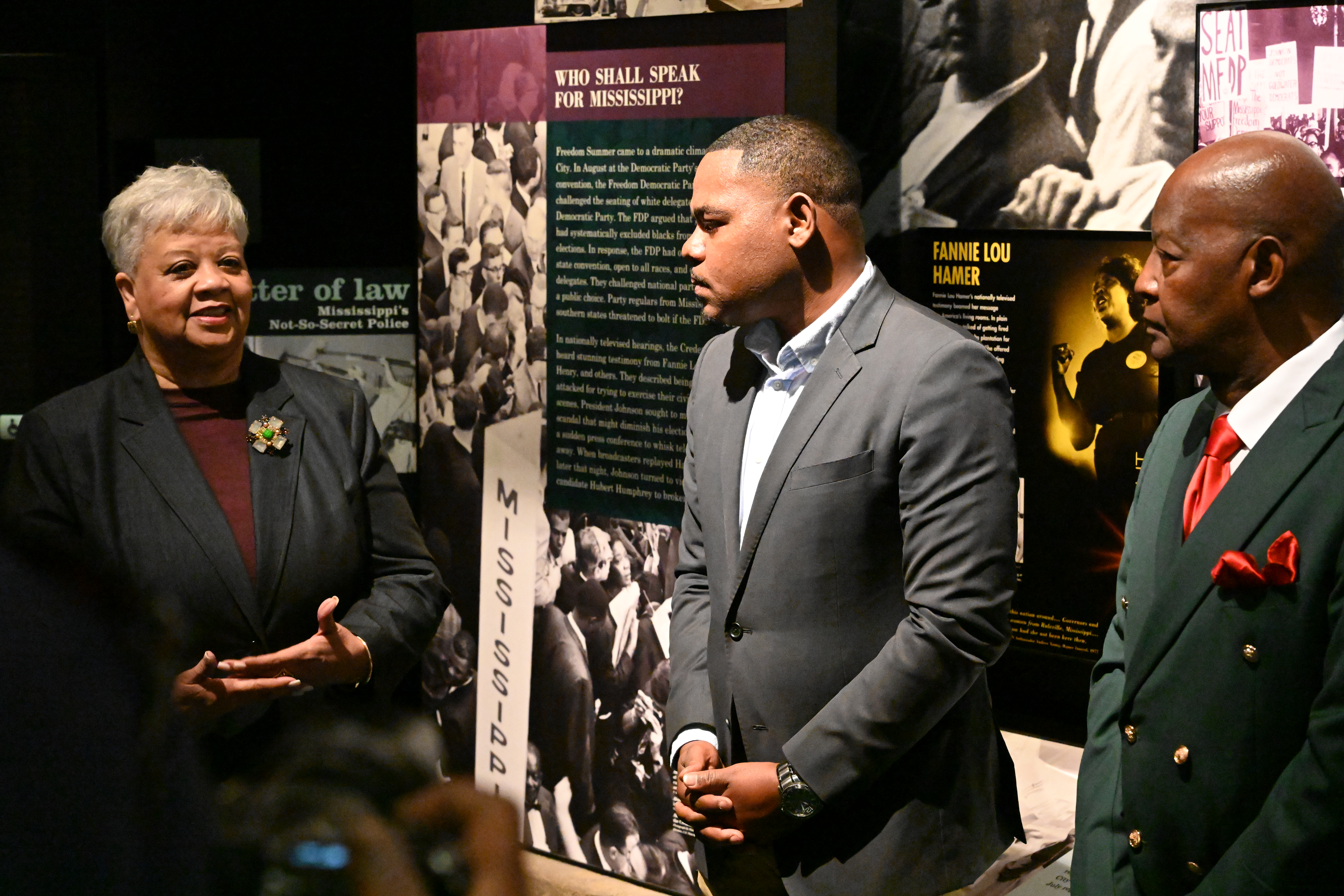 Marilyn Mays, Michael Morris, and Eddie Fair stand in exhibit