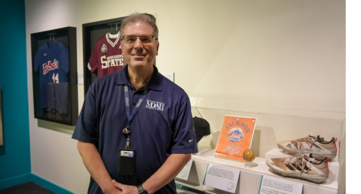 Jeff standing in front of the display with his donated Jackson Mets artifacts 